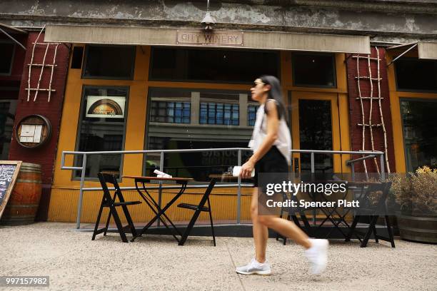 People pass the wine bar and music venue City Winery in lower Manhattan on July 12, 2018 in New York City. The Walt Disney Co., which has announced...