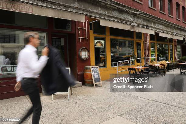 People pass the wine bar and music venue City Winery in lower Manhattan on July 12, 2018 in New York City. The Walt Disney Co., which has announced...