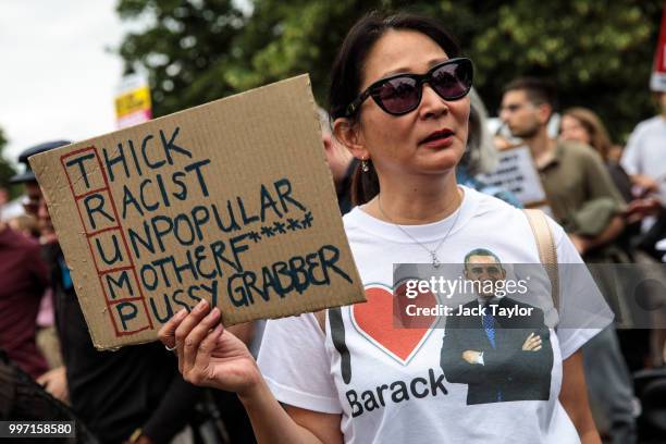 Protesters hold placards during a demonstration outside Winfield House, the London residence of US ambassador Woody Johnson, where US President...