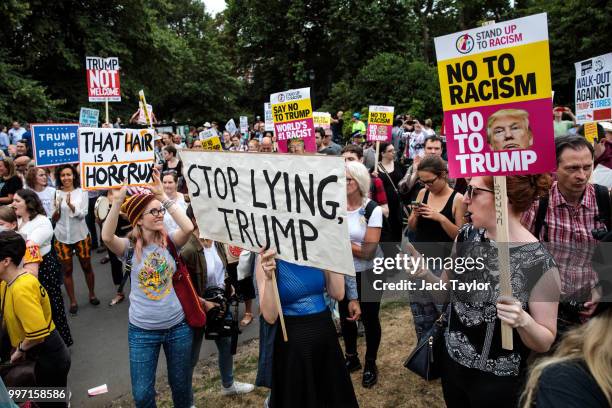 Protesters hold placards during a demonstration outside Winfield House, the London residence of US ambassador Woody Johnson, where US President...