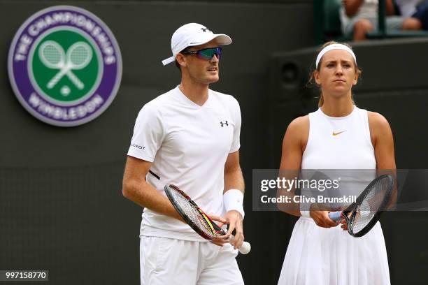 Jamie Murray of Great Britain and Victoria Azarenka of Belarus look on during their Mixed Doubles quarter-final match against Jean-Julien Rojer and...