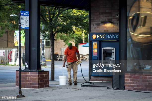 Worker prepares to wash the outside of a PNC Financial Services Group Inc. Bank branch in Chicago, Illinois, U.S., on Thursday, July 12, 2018. PNC...