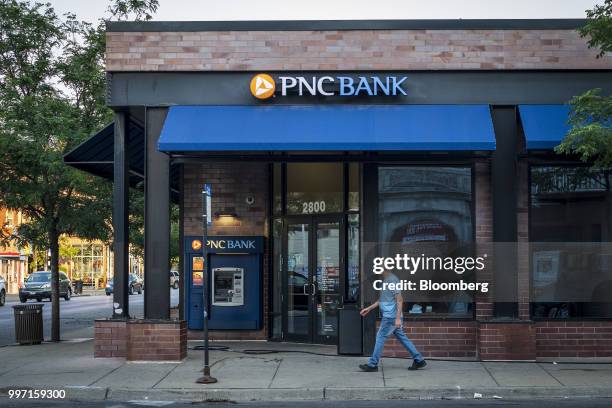 Pedestrian passes in front of a PNC Financial Services Group Inc. Bank branch in Chicago, Illinois, U.S., on Thursday, July 12, 2018. PNC Financial...