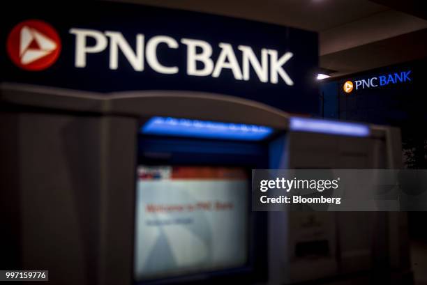 Signage is illuminated outside a PNC Financial Services Group Inc. Bank branch at night in Chicago, Illinois, U.S., on Tuesday, July 10, 2018. PNC...