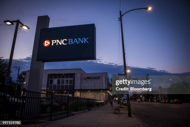 Signage is illuminated outside a PNC Financial Services Group Inc. Bank branch at night in Chicago, Illinois, U.S., on Tuesday, July 10, 2018. PNC...