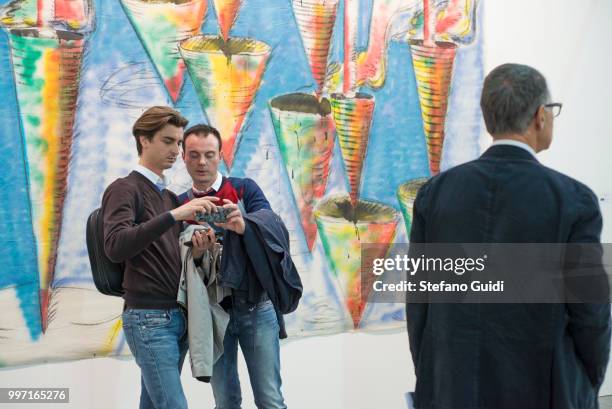 People looking at exhibits at the Artissima 2016 international exhibition of contemporary art.