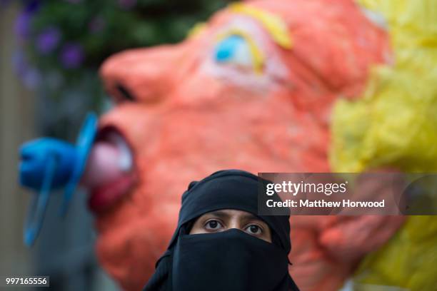 Sahar Al-Faifi stands in front of a giant Donald Trump model on Queen Street in Cardiff while protesting against a visit by U.S. President Donald...