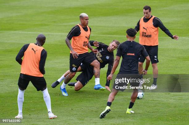 Kenedy passes the ball, whilst Florian Lejeune tackles during the Newcastle United Training session at Carton House on July 12 in Kildare, Ireland.