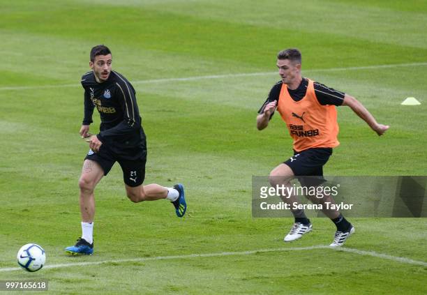 Joselu runs with the ball whilst Ciaran Clark is in pursuit during the Newcastle United Training session at Carton House on July 12 in Kildare,...