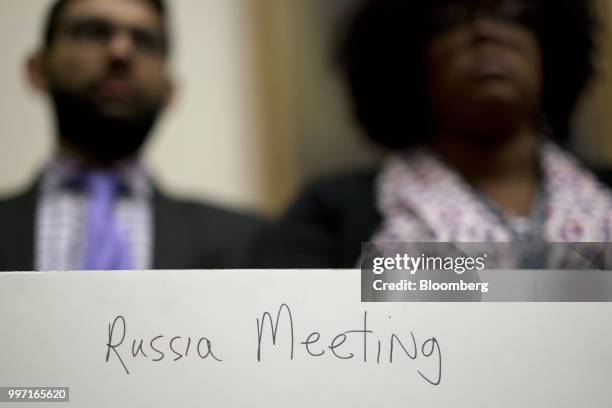 The back of a poster, held by a staff member, reads "Russia Meeting" during a joint House Judiciary, Oversight and Government Reform Committees...