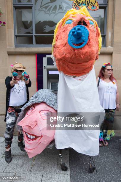 Protesters stand near a Donald Trump model on Queen Street in Cardiff while protesting against a visit by U.S. President Donald Trump on July 12,...