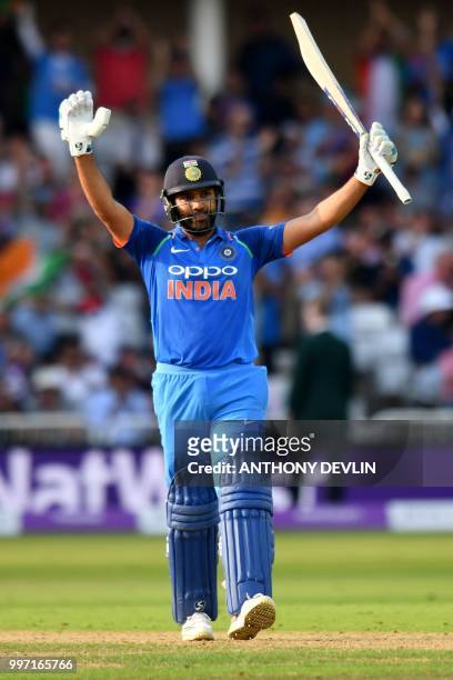 India's Rohit Sharma celebrates scoring 100 not out during the One Day International cricket match between England and India at Trent Bridge in...