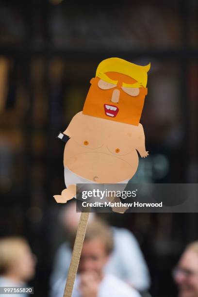 Anti-Donald Trump signs are seen as protesters gather outside Cardiff Library on the Hayes in Cardiff to protest against a visit by U.S. President...