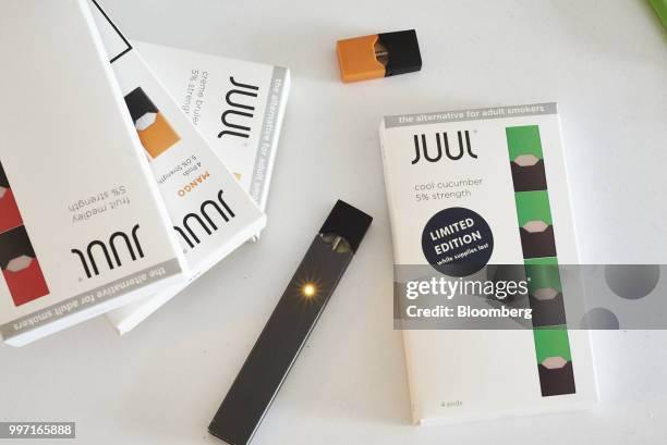 Juul Labs Inc. E-cigarette and flavored pods are arranged for a photograph in the Brooklyn Borough of New York, U.S., on Sunday July 8, 2018. Juul...