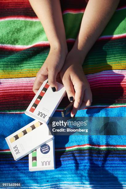 Juul Labs Inc. E-cigarette and flavored pods are arranged for a photograph in the Brooklyn Borough of New York, U.S., on Sunday July 8, 2018. Juul...