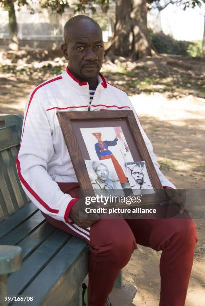 Uruanaani Scara Matundu, a representative of the Herero community can be seen with a photograph of his ancestor at a park in Windhuk, Namibia, 13 May...