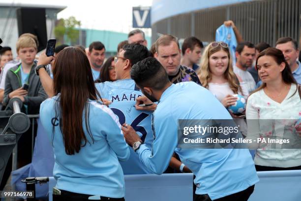 New Manchester City signing Riyad Mahrez greets and signs autographs for fans at the Etihad Stadium, Manchester.