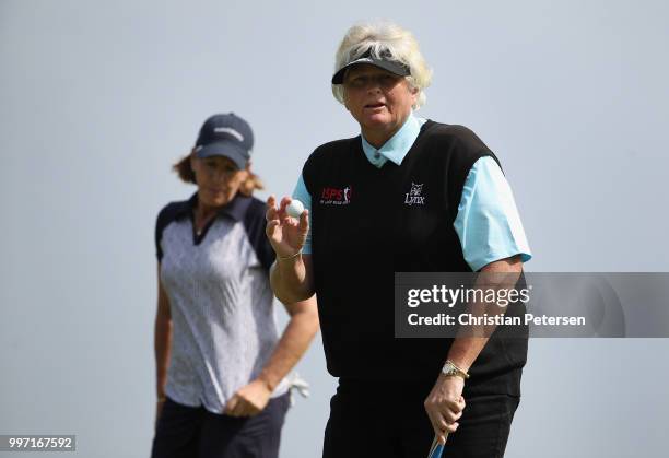 Laura Davies of England reacts to her putt on the seventh green during the first round of the U.S. Senior Women's Open at Chicago Golf Club on July...