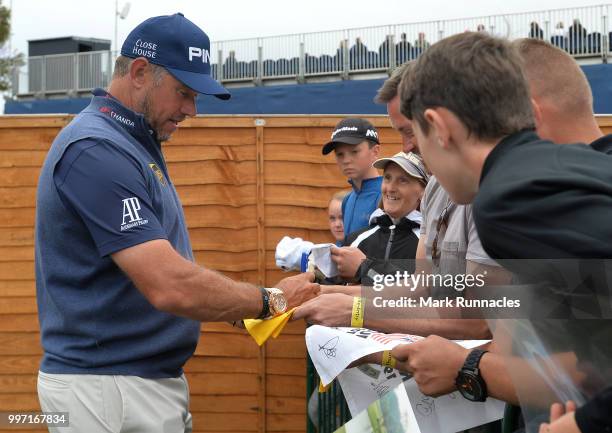 Lee Westwood of England signs autographs at the 18th during the first day of the Aberdeen Standard Investments Scottish Open at Gullane Golf Course...