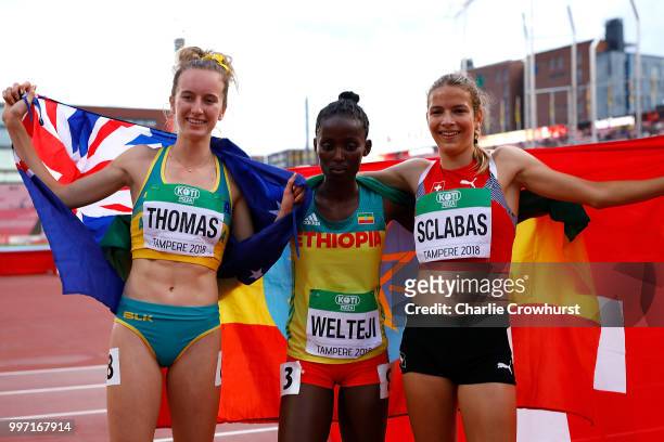 Carly Thomas of Australia, Diribe Welteji of Ethiopia and Delia Sclabas of Switzerland celebrate winning medals in the final of the women's 800m on...