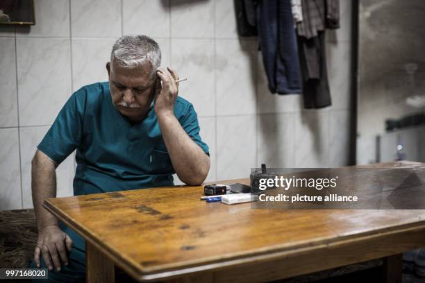 Hassan Ibrahim, head of the general hospital of West-Mossul smokes a cigarette in Mossul, Iraq, 21 September 2017. After 9 months of fighting against...