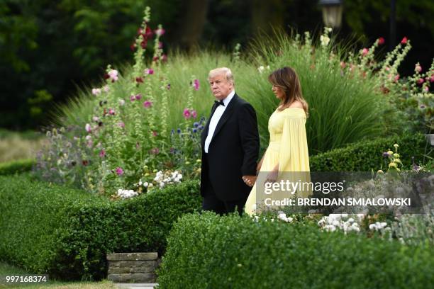 President Donald Trump and US First Lady Melania Trump leave the US ambassador's residence, Winfield House, in London on July 12 heading to Blenheim...