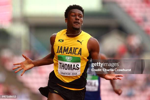 Damion Thomas of Jamaica celebrates as he crosses the line to win gold in the final of the men's 110m hurdles during the XX on day three of The IAAF...