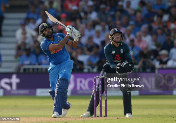 Rohit Sharma of India hits a six as Jos Buttler looks on during the 1st Royal London One-Day International between England and India on July 12, 2018...