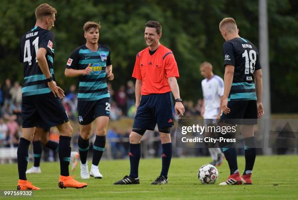 Florian Krebs of Hertha BSC, referee Toni Bauer and Sinan Kurt of Hertha BSC during the game between MSV Neuruppin against Hertha BSC at the...