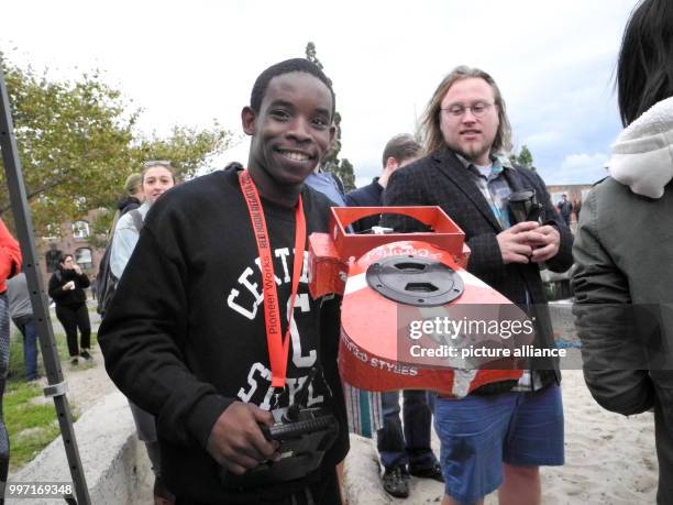 Participant shows a model boat from a 3D printer with which he will participate in the Red Hook Regatta in Brooklyn, Germany, 30 September 2017. Who...