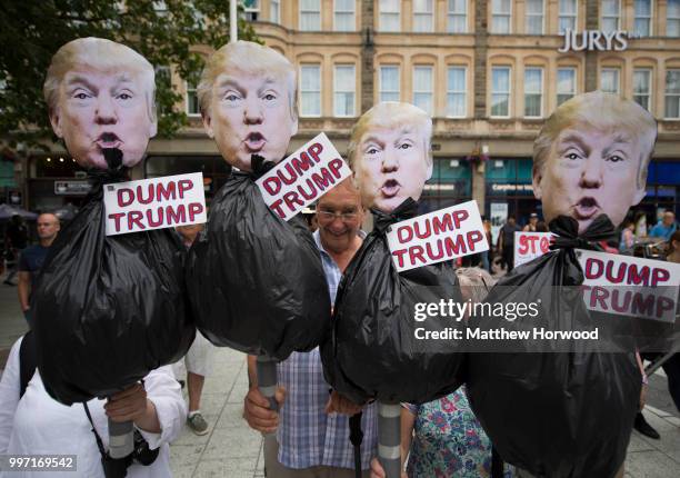 Protesters hold anti-Donald Trump signs during a protest on Queen Street against a visit by U.S. President Donald Trump on July 12, 2018 in Cardiff,...