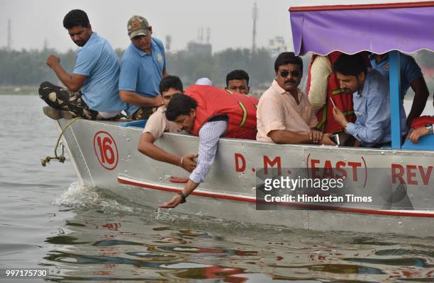 Delhi BJP President Manoj Tiwari along with government officials inspects the proposed water taxi route during his visit to the Yamuna river bank, at...