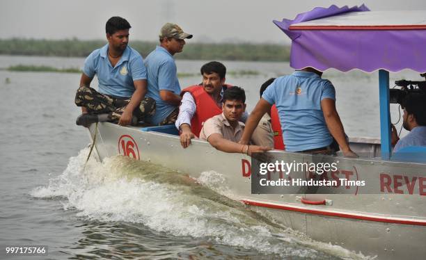 Delhi BJP President Manoj Tiwari along with government officials inspects the proposed water taxi route during his visit to the Yamuna river bank, at...