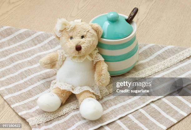 green pastel porcelain jar and little bear doll wi - hood ornament stock pictures, royalty-free photos & images