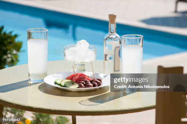 ouzo and tasters in front of swimming pool. - ouzo stock pictures, royalty-free photos & images