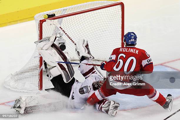 Tomas Rolinek of Czech Republic scores his team's first goal against goalkeeper Edgars Masalskis of Latvia during the IIHF World Championship group F...