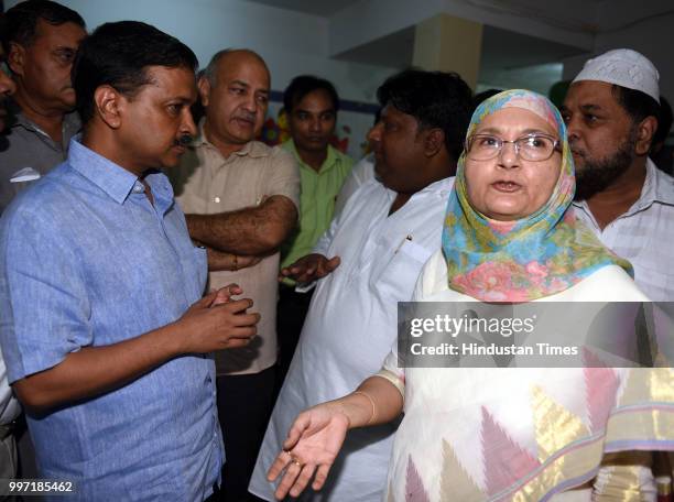 Delhi Chief Minister Arvind Kejriwal, Deputy chief Minister Manish Sisodia, Local AAP MLA and environment minister Imran Hussain speak with the...
