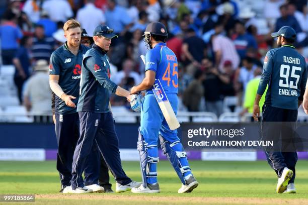 India's Rohit Sharma shakes hands with England's Eoin Morgan after India won the One Day International cricket match between England and India at...