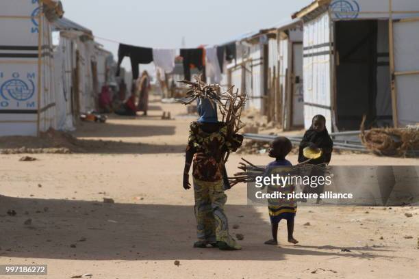Refugees standing in the Bakassi refugee camp in Maiduguri, Nigeria, 28 June 2017. Millions of people have been displaced by the terrorist militia...