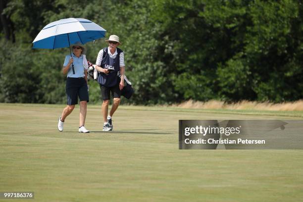 Barb Moxness walks the eighth fairway with her caddie during the first round of the U.S. Senior Women's Open at Chicago Golf Club on July 12, 2018 in...