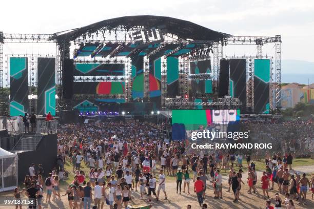 People attend the Electro Beach festival in Barcares, southern France on July 12, 2018.