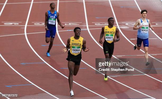 Damion Thomas of Jamaica celebrates as he crosses the line to win gold in the final of the men's 110m hurdles during the XX on day three of The IAAF...