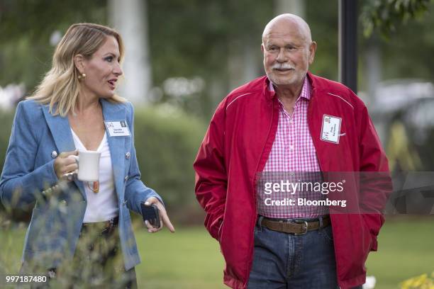 Pete Karmanos, co-owner and chief executive officer of the Carolina Hurricanes, and Danialle Karmoanos arrive for a morning session during the Allen...