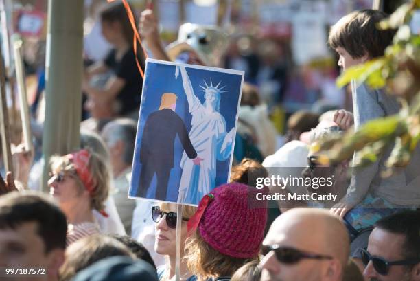 Protesters gather at the gates of Blenheim Palace where U.S. President Donald Trump is due at a evening function in Woodstock on July 12, 2018 in...