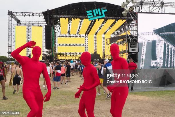 People attend the Electro Beach festival in Barcares, southern France on July 12, 2018.