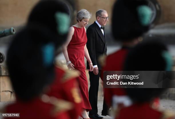 Britain's Prime Minister Theresa May and her husband Philip May wait for the arrival of U.S. President Donald Trump and First Lady Melania Trump at...