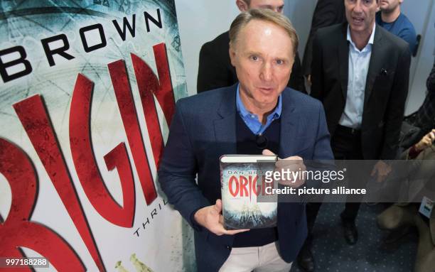 American author Dan Brown presenting his book "Origin" while surrounded by photographers and television crews at the Frankfurt Book Fair in Frankfurt...