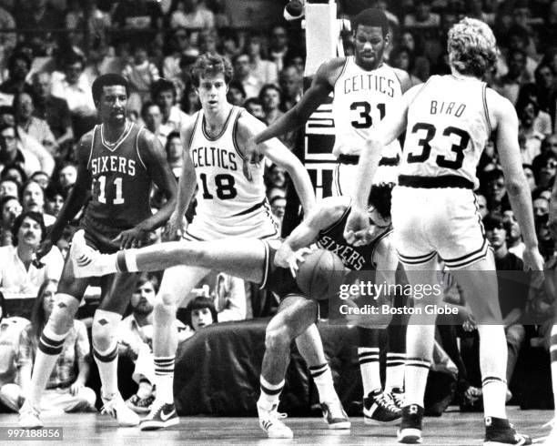 Boston Celtics' Cedric Maxwell fouls Philadelphia's Bobby Jones as Philadelphia's Caldwell Jones and the Celtics' Dave Cowens and Larry Bird look on...