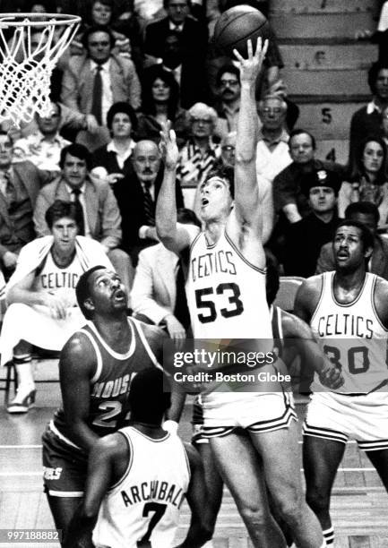 Houston Rockets' Moses Malone looks up as the Celtics' Rick Robey scores two points during the second quarter of Game Two of the first round of the...