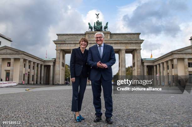 President Frank-Walter Steinmeier and his wife Elke Budenbender standing at the Pariser Platz in front of the Brandenburg Gate on the occasion of his...